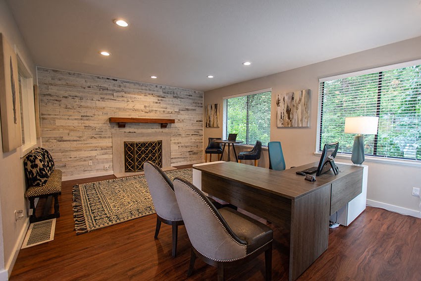 a home office with a fireplace and a desk