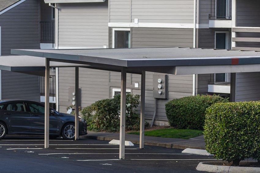 a parking lot with a car parked under a canopy