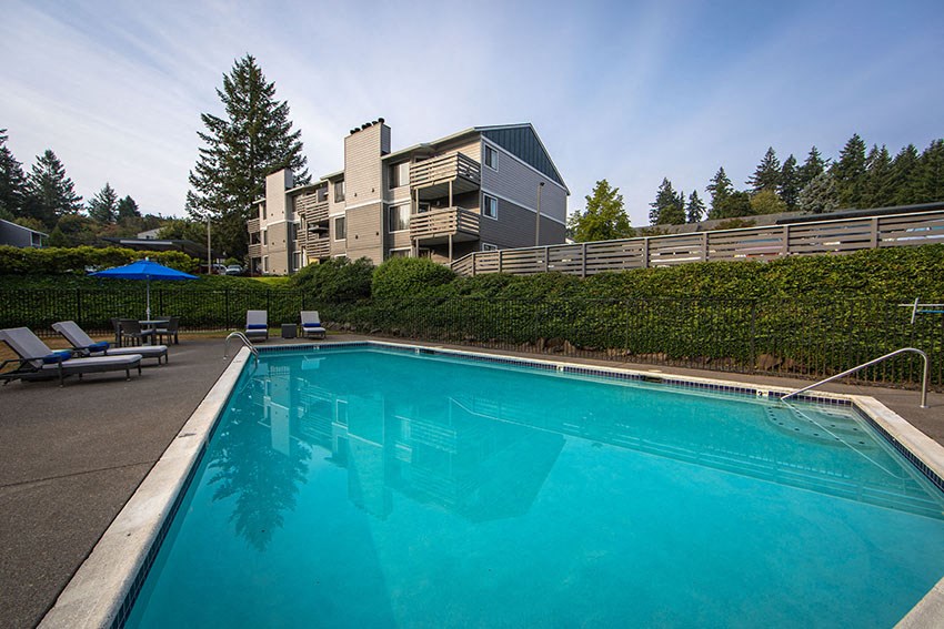 a swimming pool with a building in the background