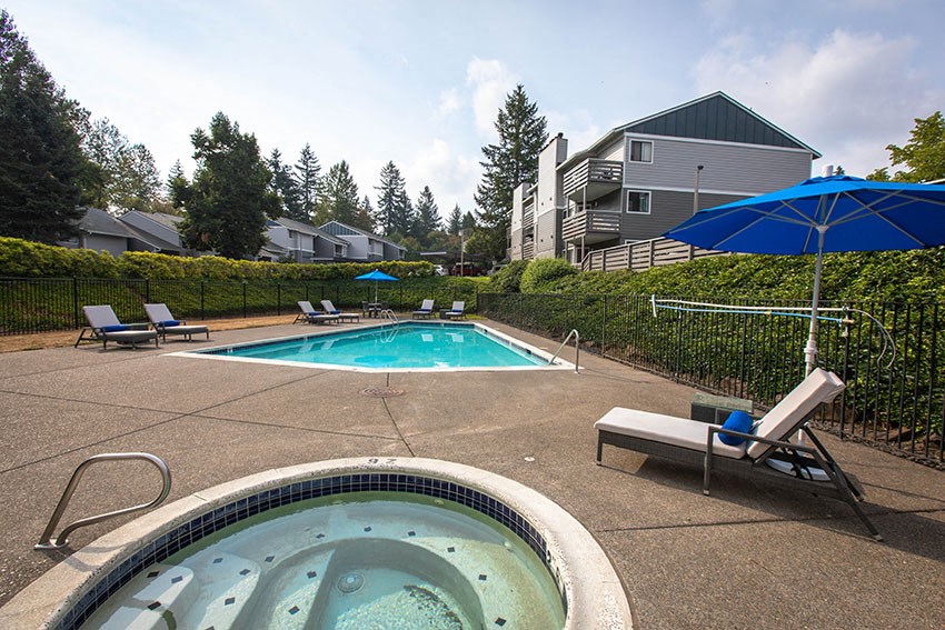 a pool with chairs and umbrellas next to a swimming pool