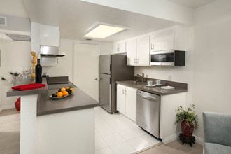 a kitchen with a sink and a refrigerator