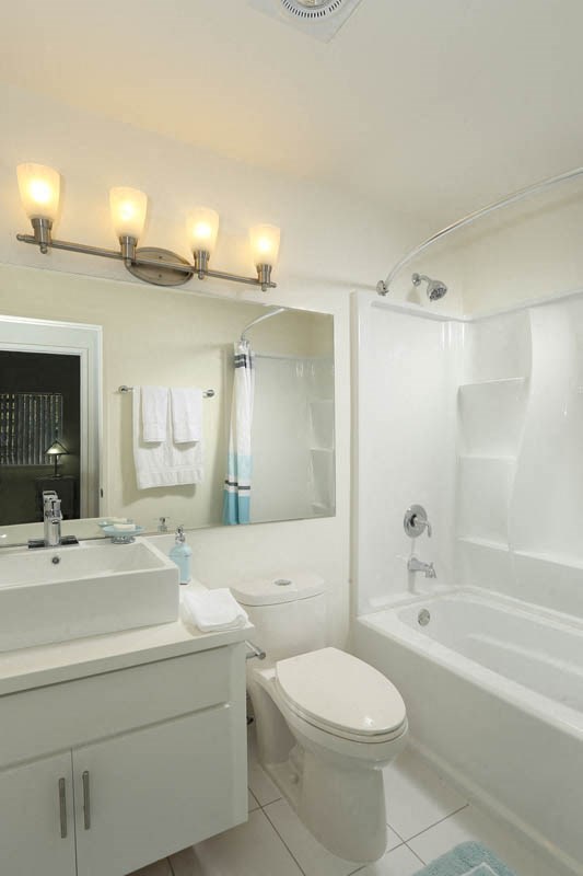 a bathroom with a sink toilet and a tub