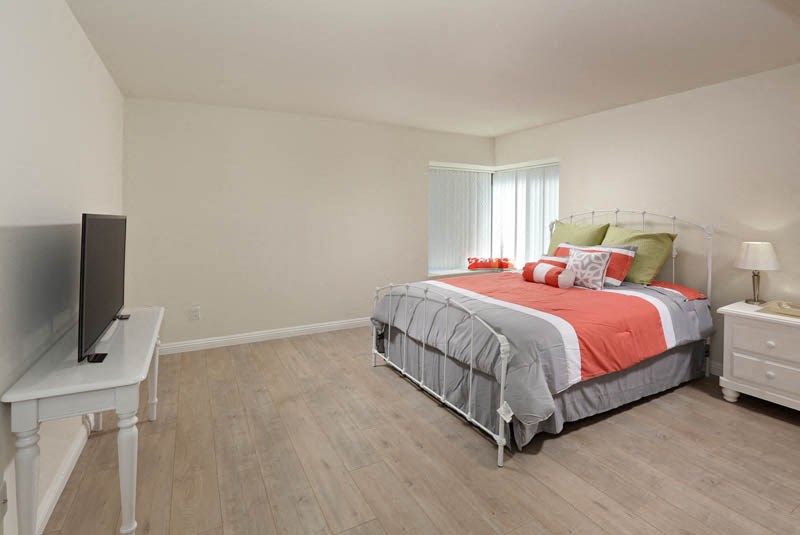 a bedroom with a bed and a television