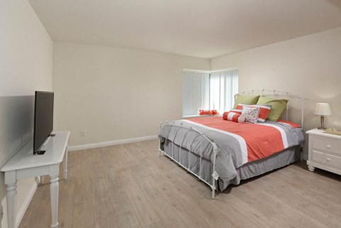 a bedroom with a bed and a television
