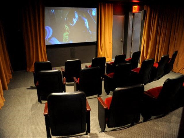 a large room with chairs and a projection screen