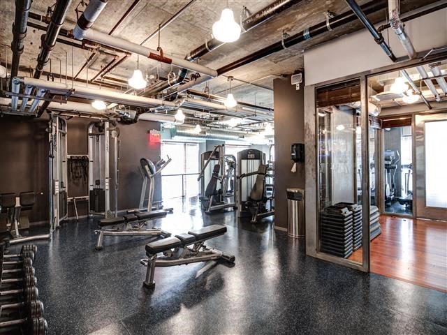 a gym with weights and other exercise equipment in a building