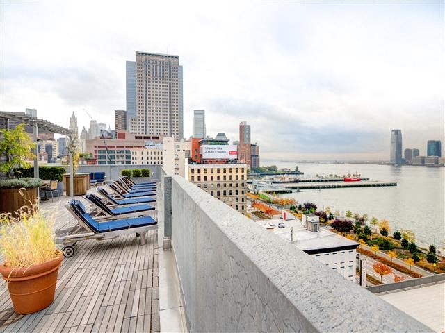 a balcony with a view of a city and a river