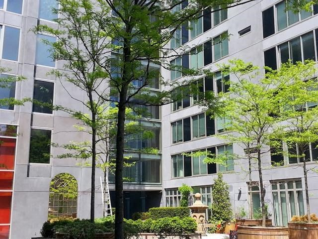 a tall building with trees in front of it