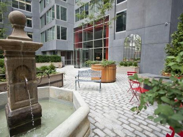a courtyard with a water fountain and a table and chairs