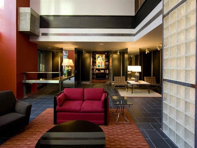 a living room with a red couch and a table