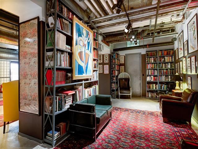 a library with a bunch of books and a couch