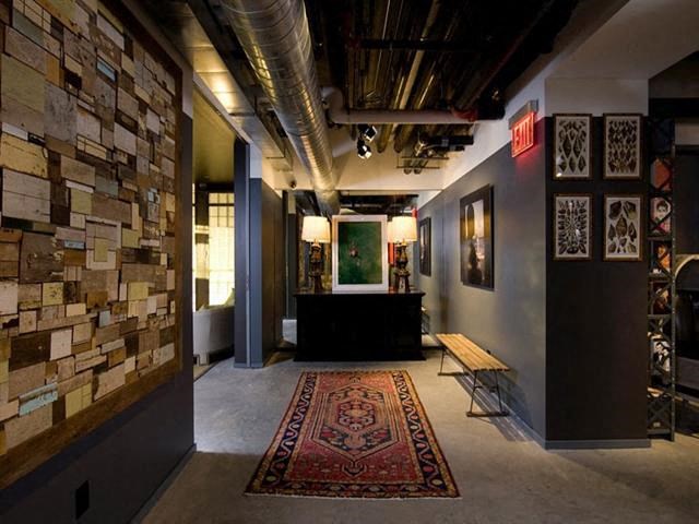 the lobby of a building with a rug and a table