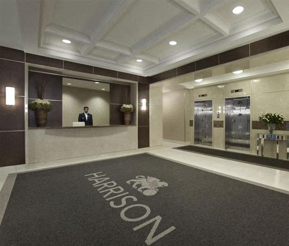 A reception area with a carpet that says Harrison.