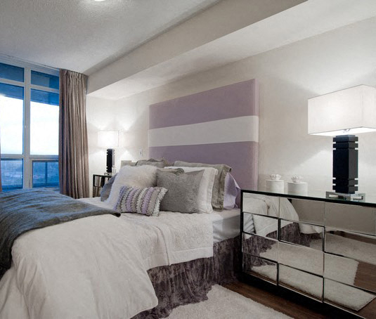 A bedroom with a large bed and a large window.