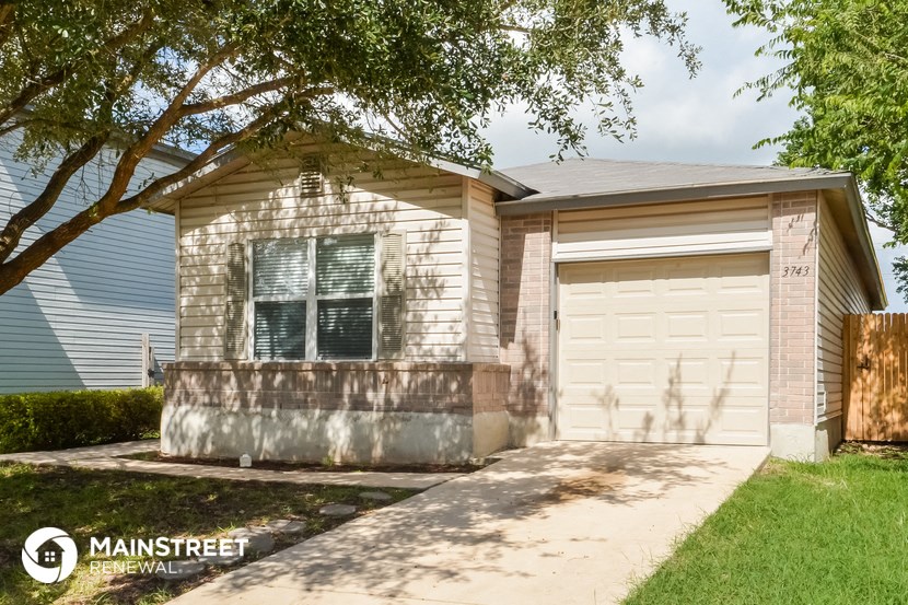 a white brick house with a white garage door