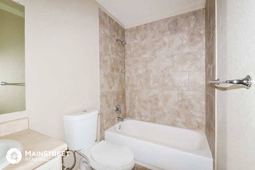 a bathroom with a tub and a toilet and a sink