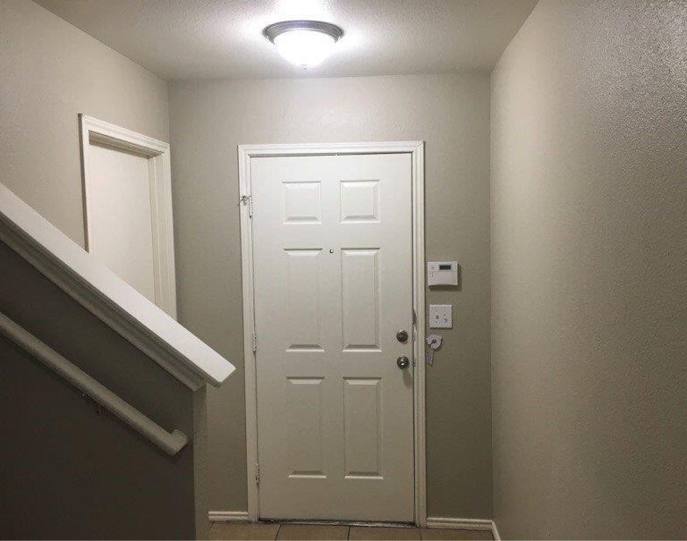 a white door in a hallway with a light above it
