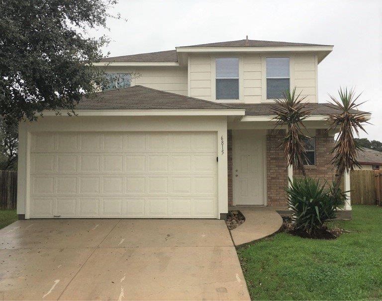 a white garage door in front of a house