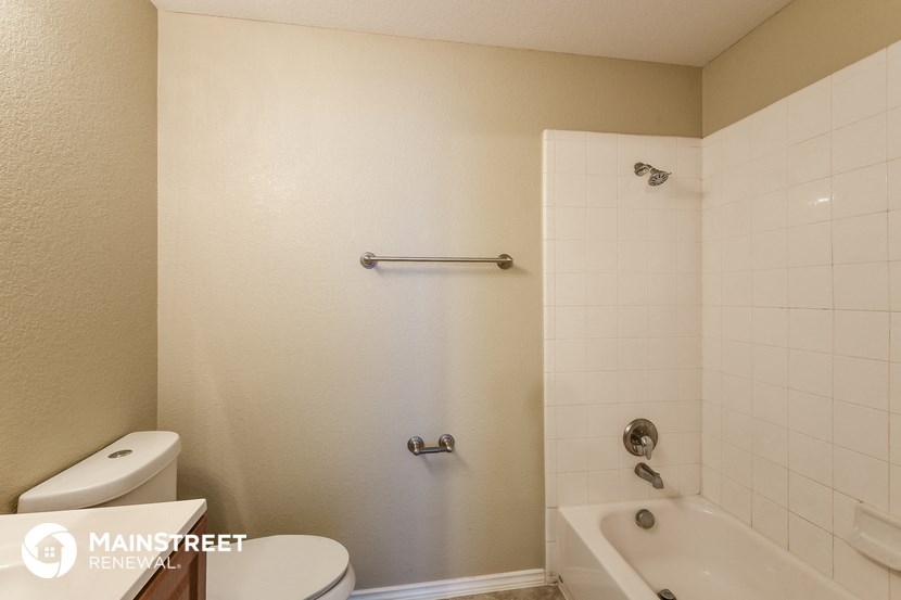 a bathroom with a tub and a toilet and a sink