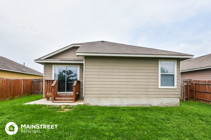 the front of a house with a yard and grass