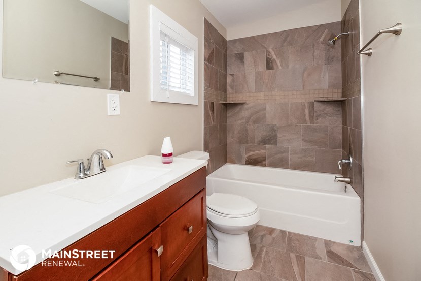 a bathroom with a toilet and a sink and a tub