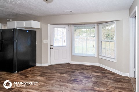 a kitchen with a refrigerator and a window