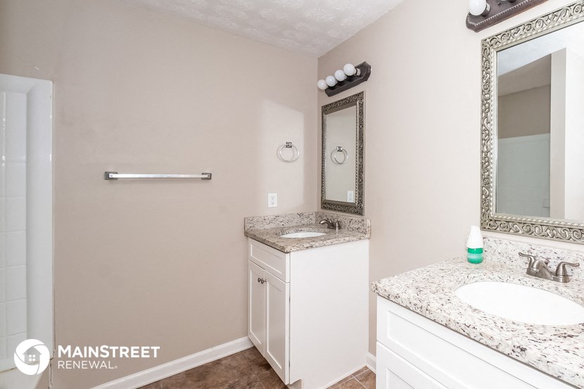 a bathroom with a sink and a mirror and a toilet