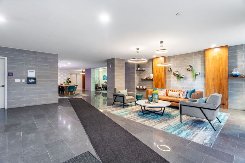 a lobby with couches and chairs and a table