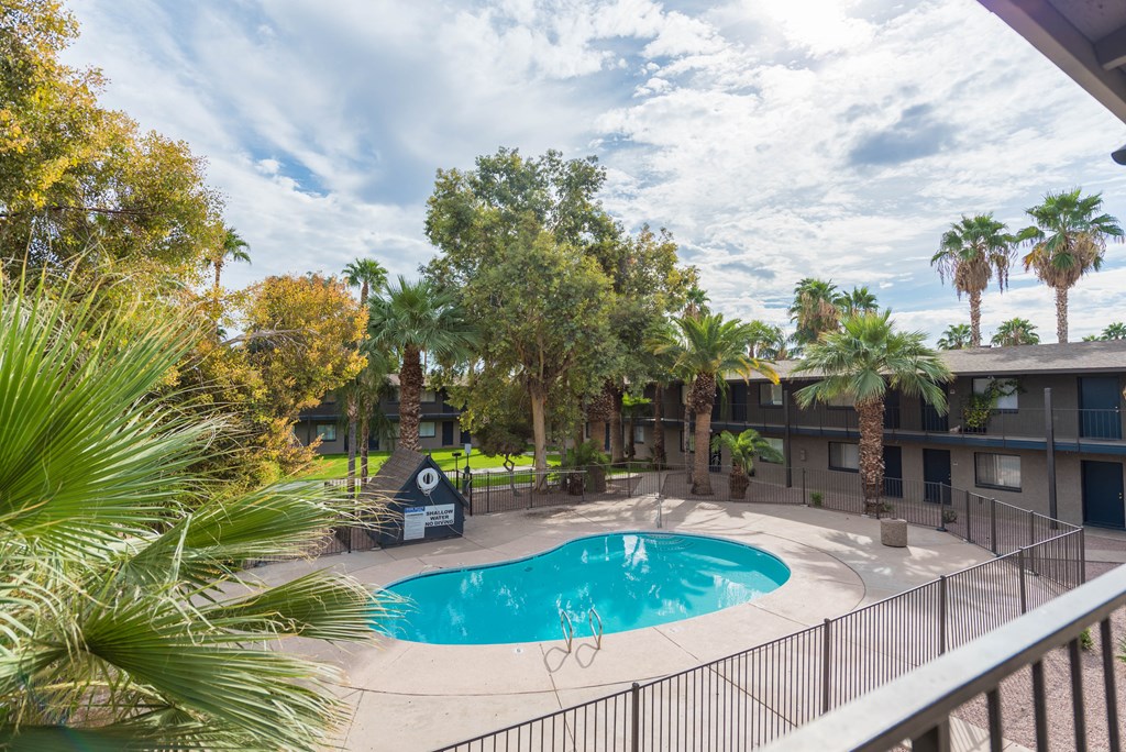 a resort style pool is surrounded by palm trees