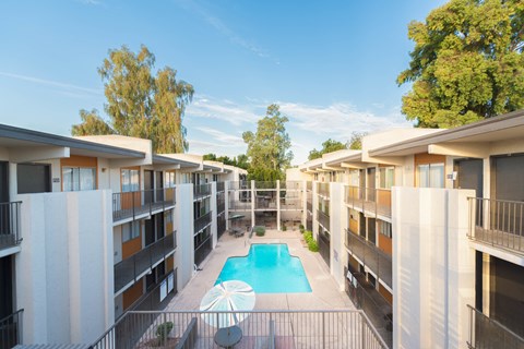 a view of a pool in the middle of apartment buildings