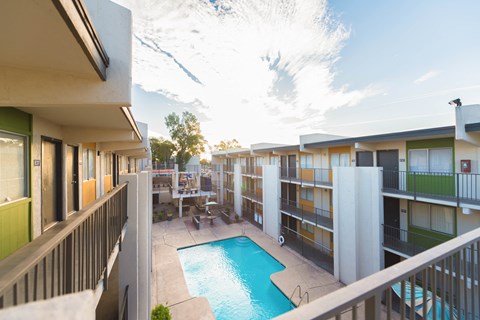 a view of a pool and a building with a blue sky