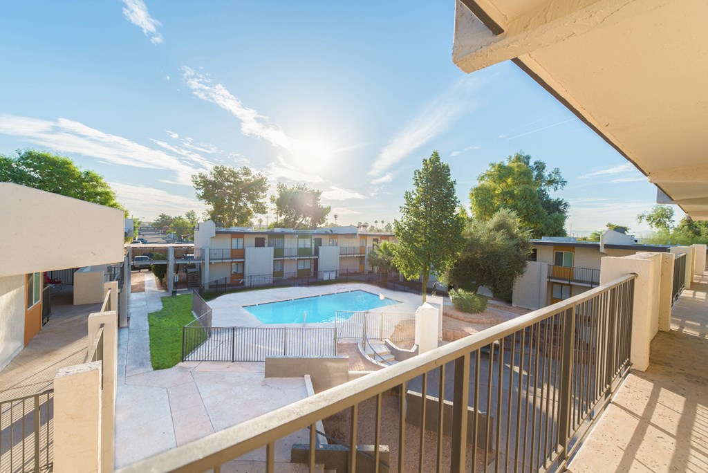 a view of the pool from the balcony of an apartment building