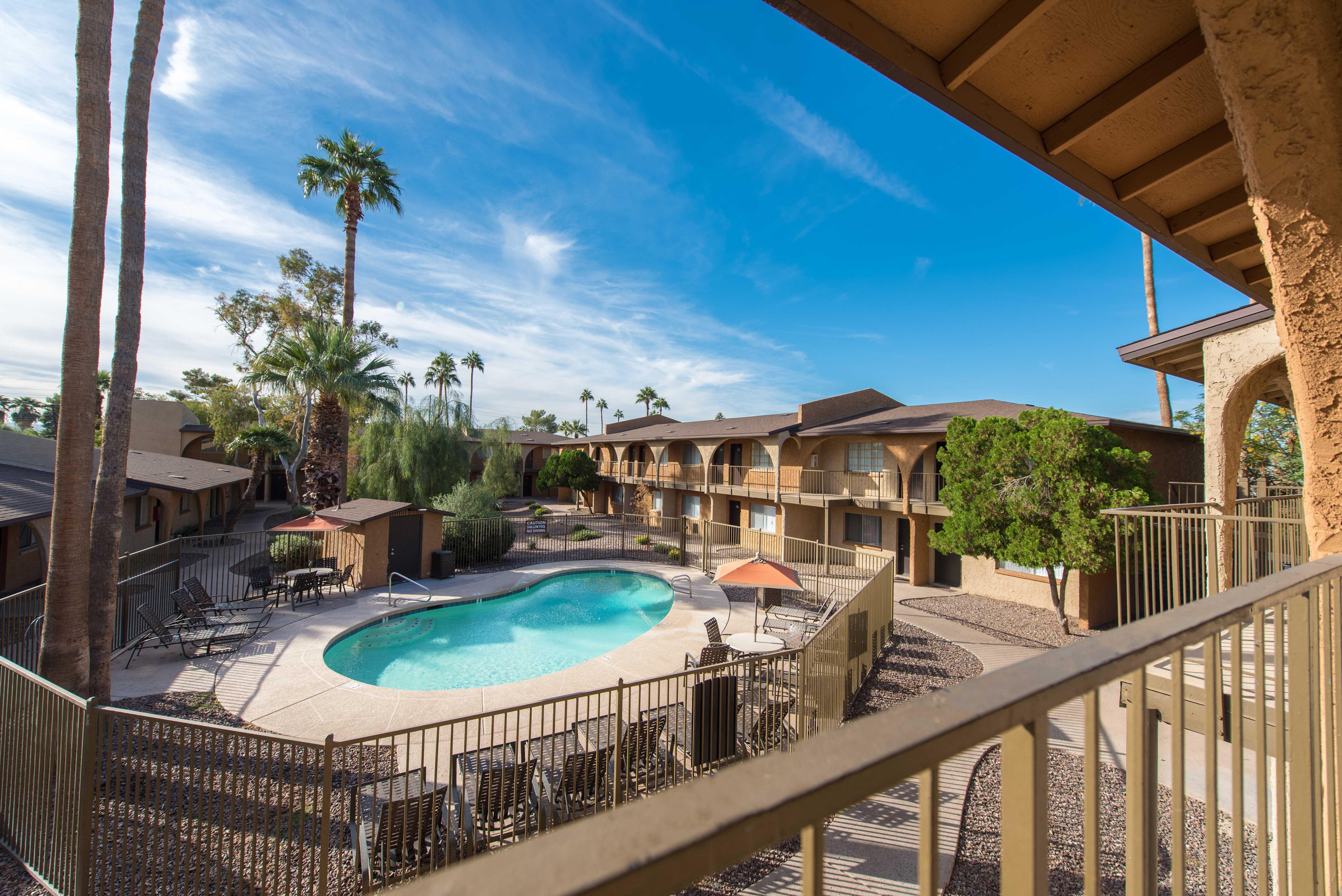 a view of a pool and a resort building with a pool