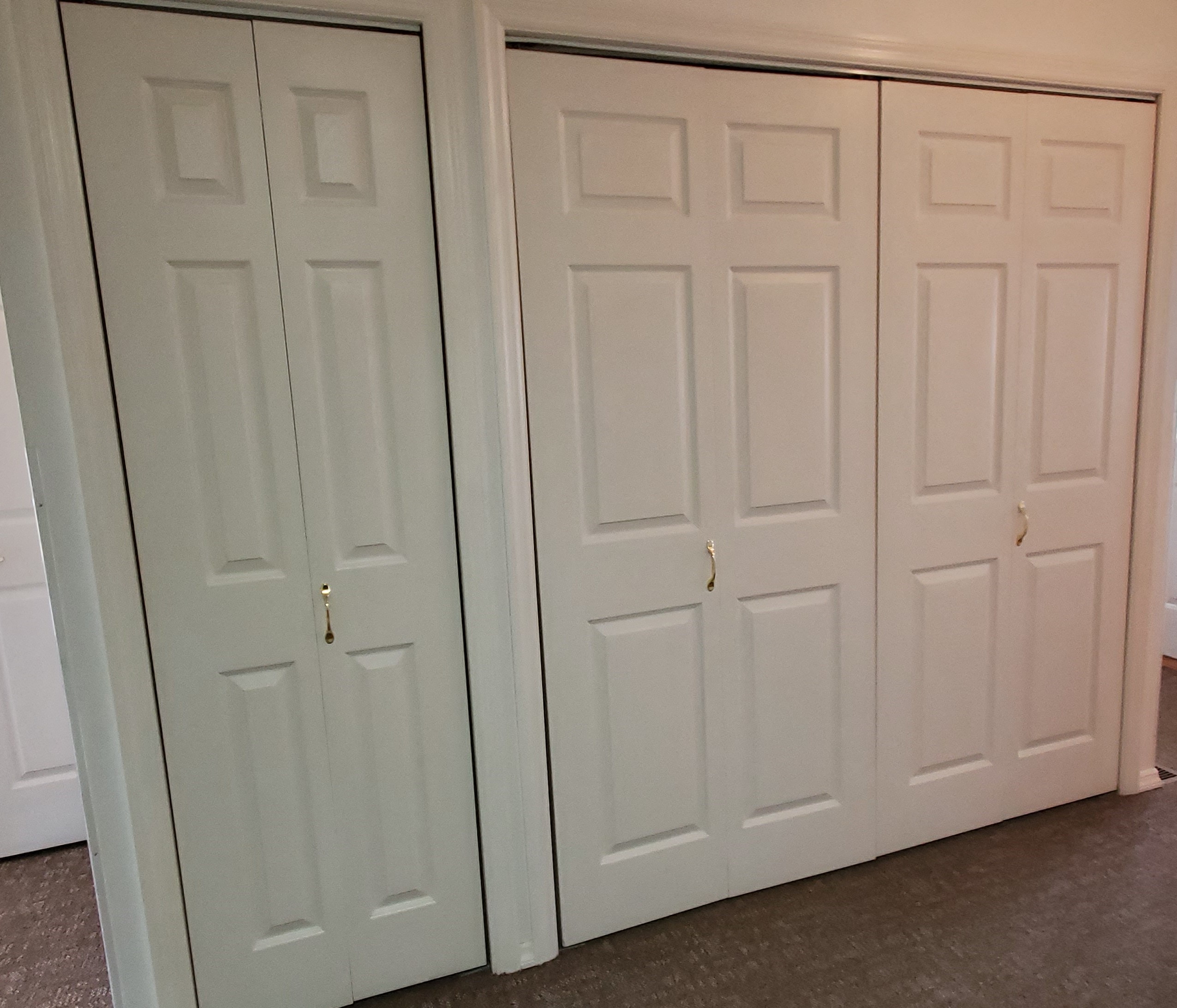 a pair of white closet doors in a room