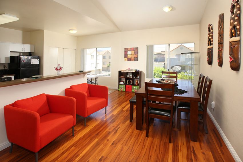 a dining room and living room with a table and chairs