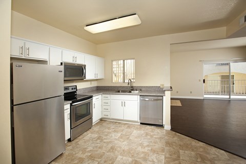 a kitchen with stainless steel appliances and white cabinets