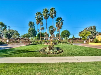 Entry grass with sidewalk Ontario, Ca Apartment rentals l The Casitas Apartments