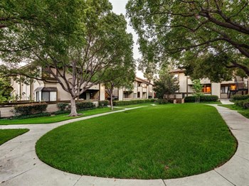 Grass area with sidewalk to apts 91325 northridge 1 and 2 bedroom rentals at grand on lindley