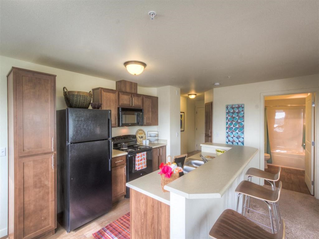 Kitchen with breakfast countertop | Urban Center apartments in Lynnwood