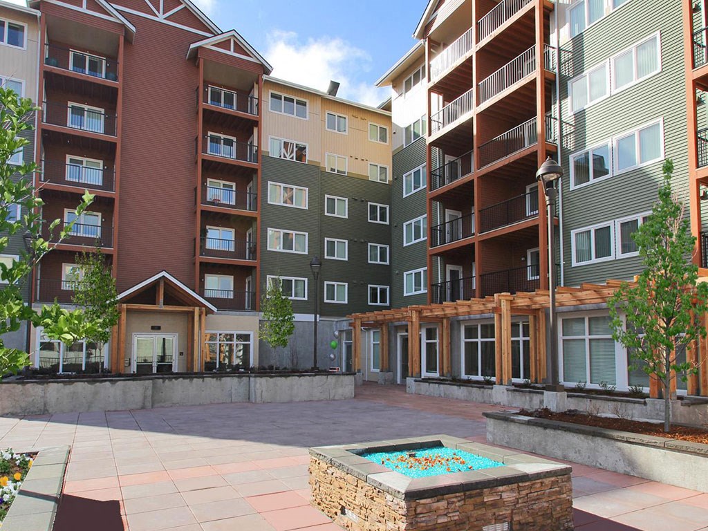 Lynnwood, WA Apartments - Urban Center - Courtyard with Planters, Trees, and a Fire Pit