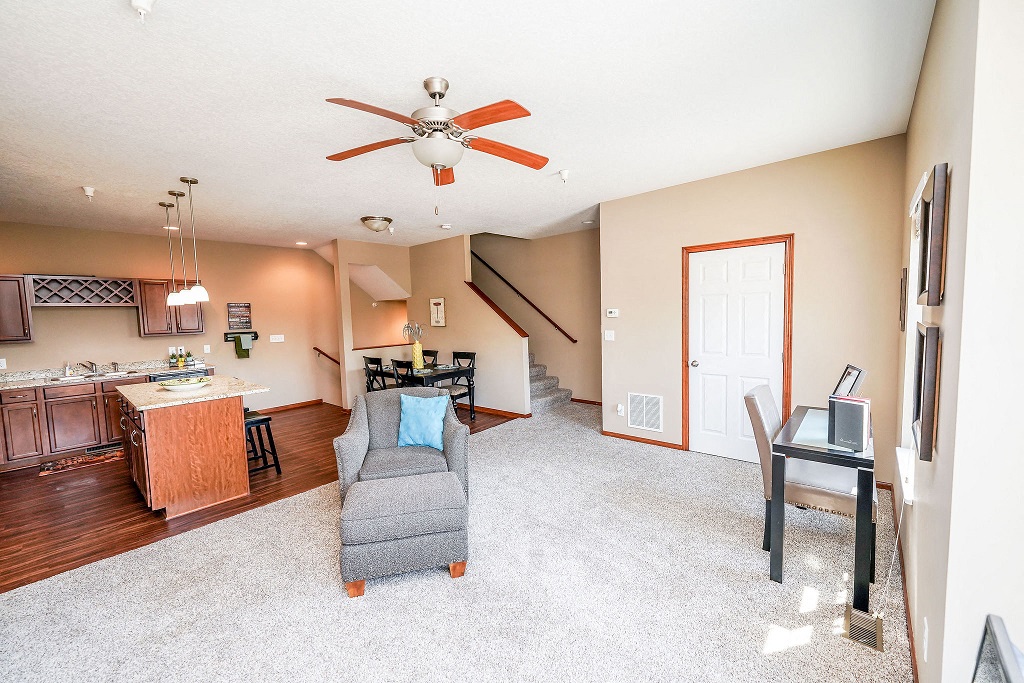 a living room with a couch and a ceiling fan