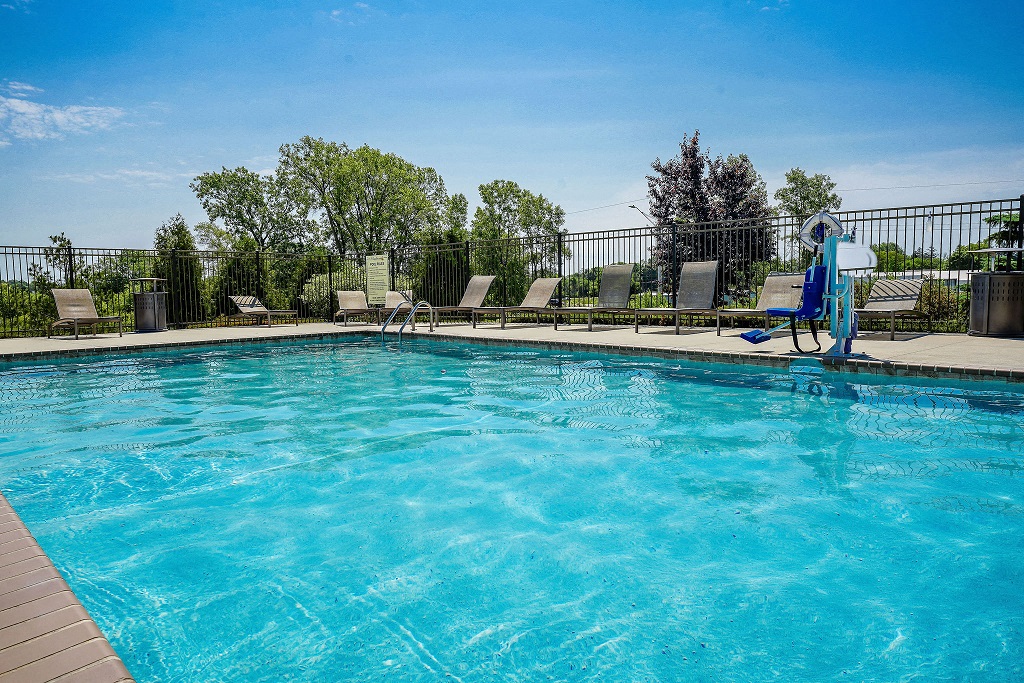 a swimming pool with chaise lounge chairs and a water slide