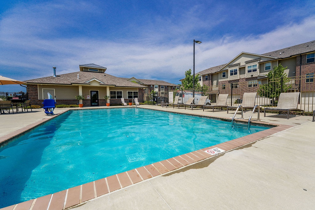 a swimming pool with a building in the background