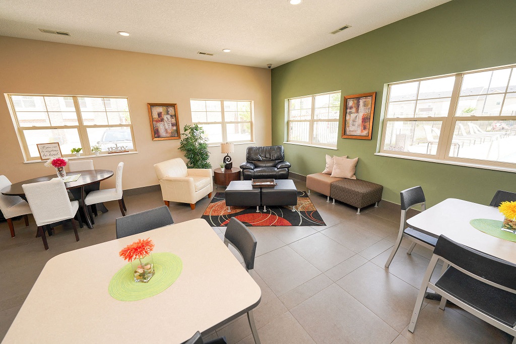 a dining room and living room with a table and chairs