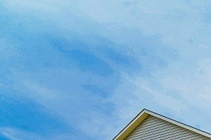 a house with a sign in front of it on a lawn
