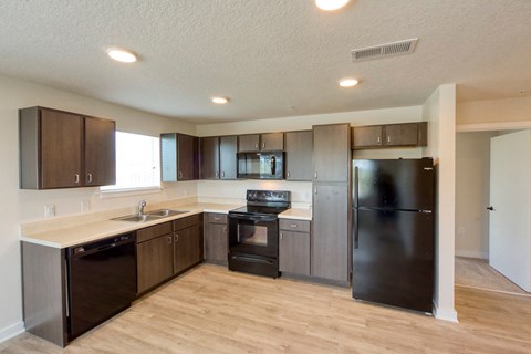 a kitchen with stainless steel appliances and wooden cabinets