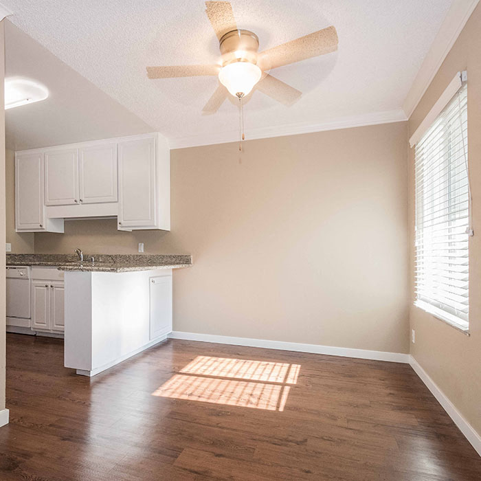 Walnut Creek CA Apartments for Rent - The Meridian - Dining Area with Wood-Style Flooring, Tan Walls, and Ceiling Fan