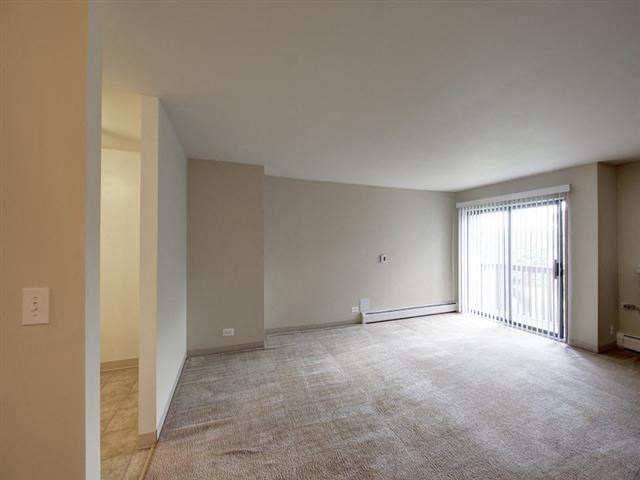 an empty living room with a sliding glass door