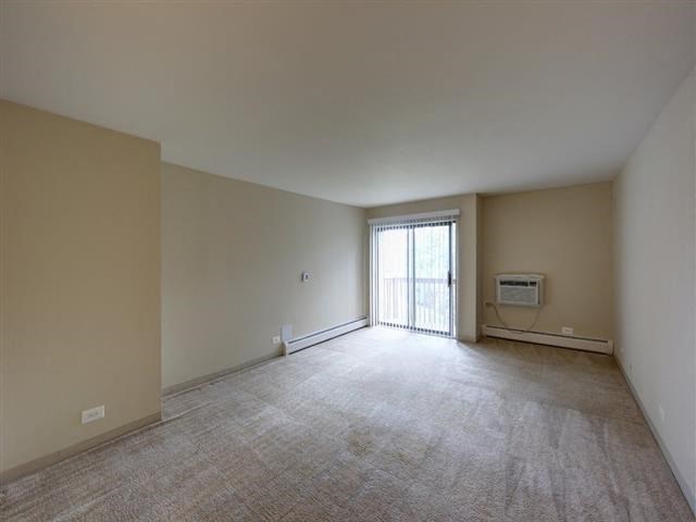 an empty living room with a sliding glass door
