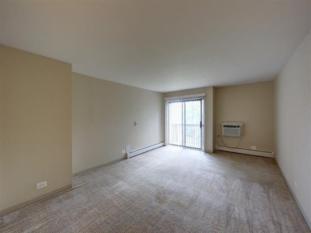an empty living room with a sliding glass door